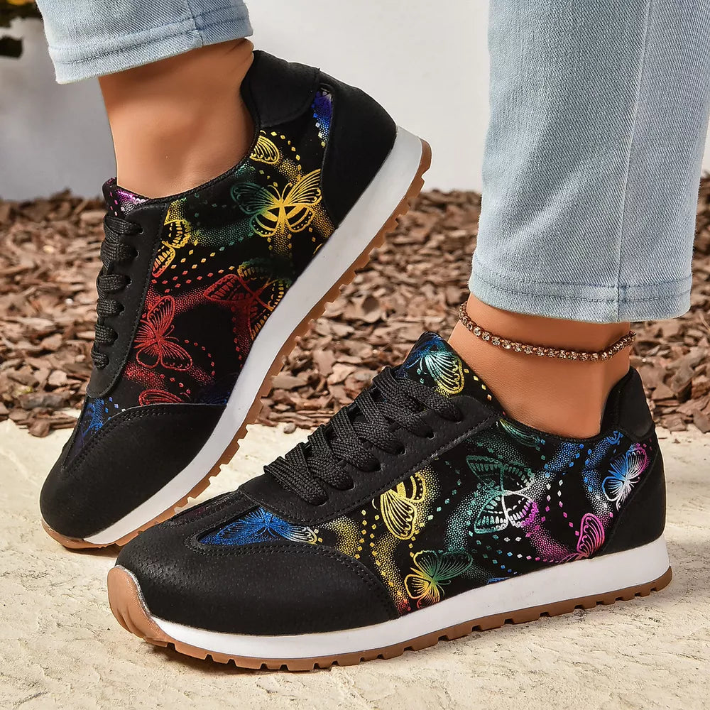 Black casual sneakers with a colorful rainbow butterfly print and white soles.