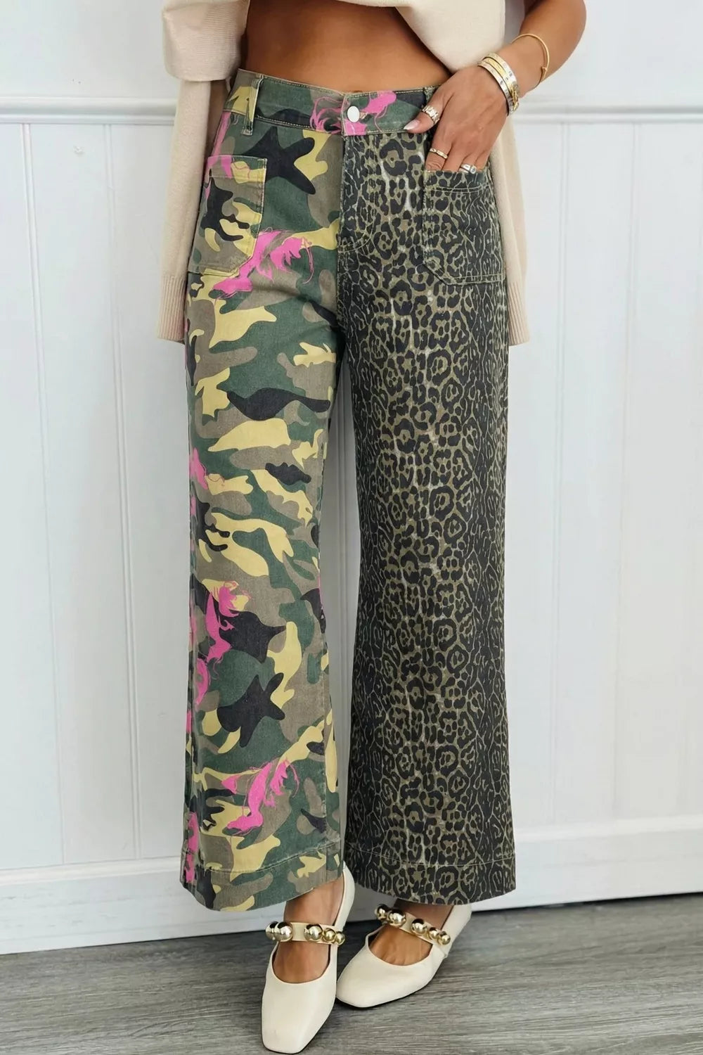 Contrast patchwork jeans with camo and leopard print, featuring pink accents.