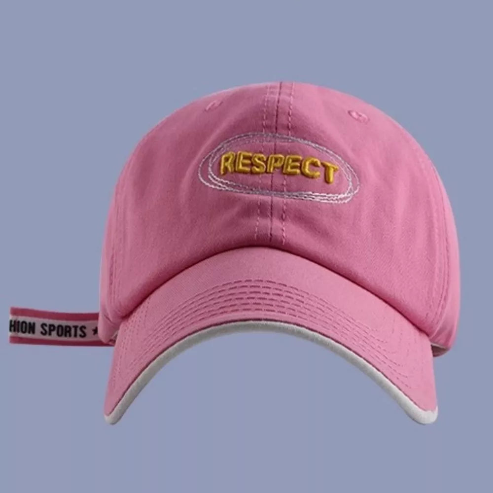 Pink baseball cap with embroidered "RESPECT" detail and side strap.
