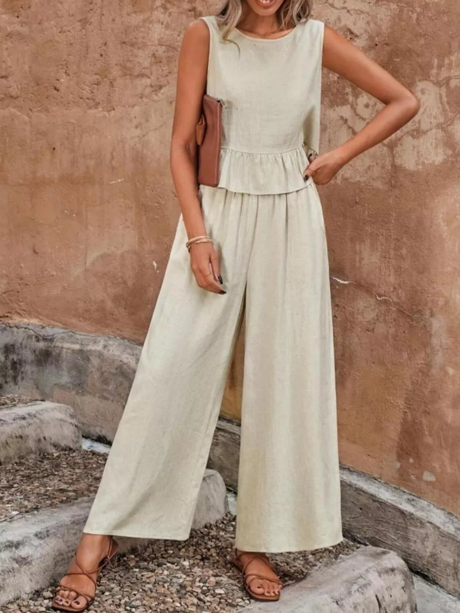 Beige ruffled peplum top and wide-leg pants set with round neckline and sleeveless design.