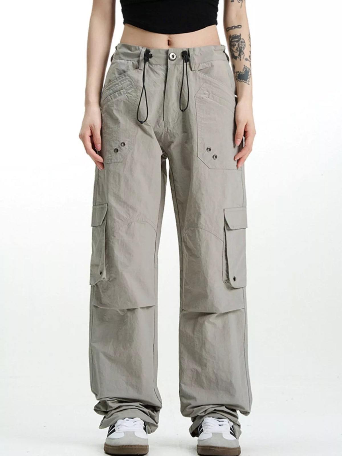 Relaxed fit grey cargo pants with multiple pockets and drawstring waist.