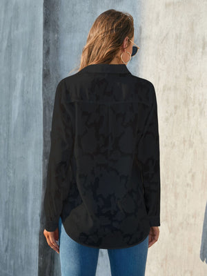 Black sheer button-down blouse with tonal floral embroidery and long sleeves.