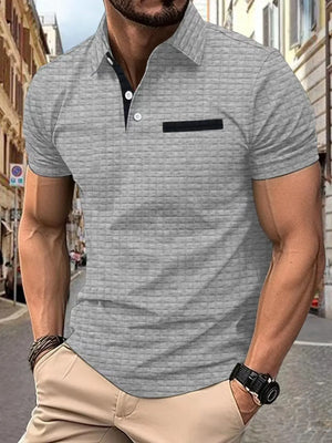 Gray textured polo shirt with contrast black pocket detail and collar.