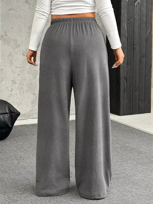 Maternity pants in gray with a drawstring waist and wide legs.