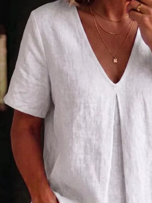 White linen v-neck short sleeve top with subtle pleating detail.