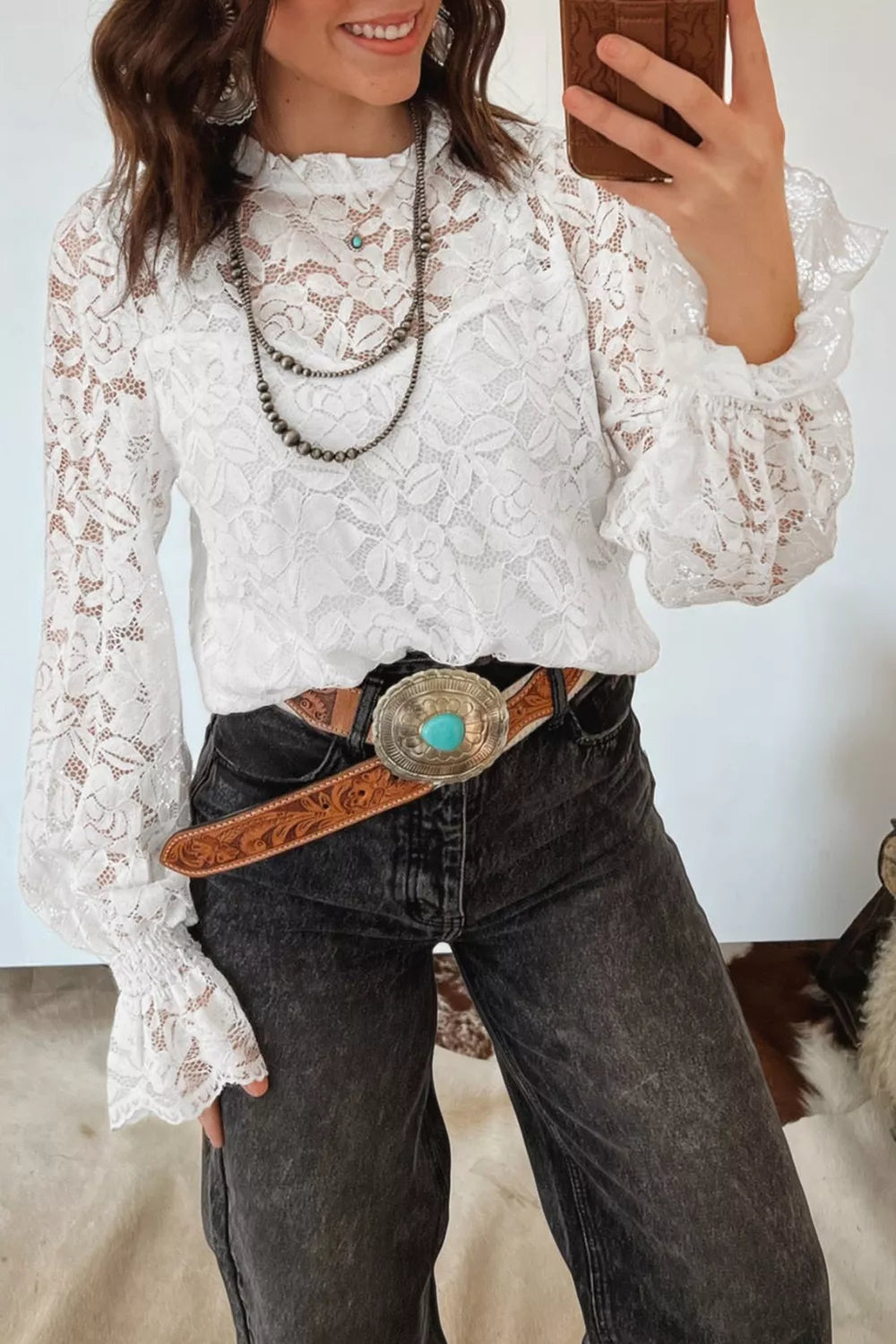 White lace blouse with ruffled neckline and bell sleeves