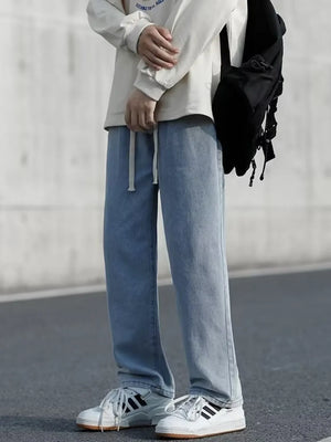 Men's light blue loose-fit jeans with drawstring waist and pockets.
