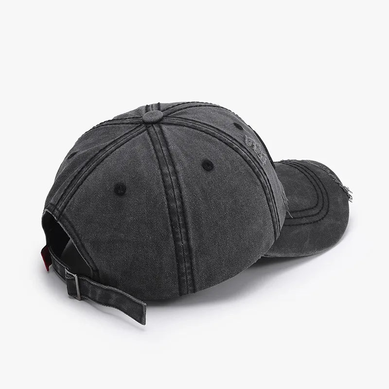 Black cotton baseball cap with distressed details and adjustable strap