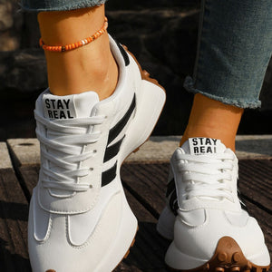 black sneakers featuring round toe and color-block