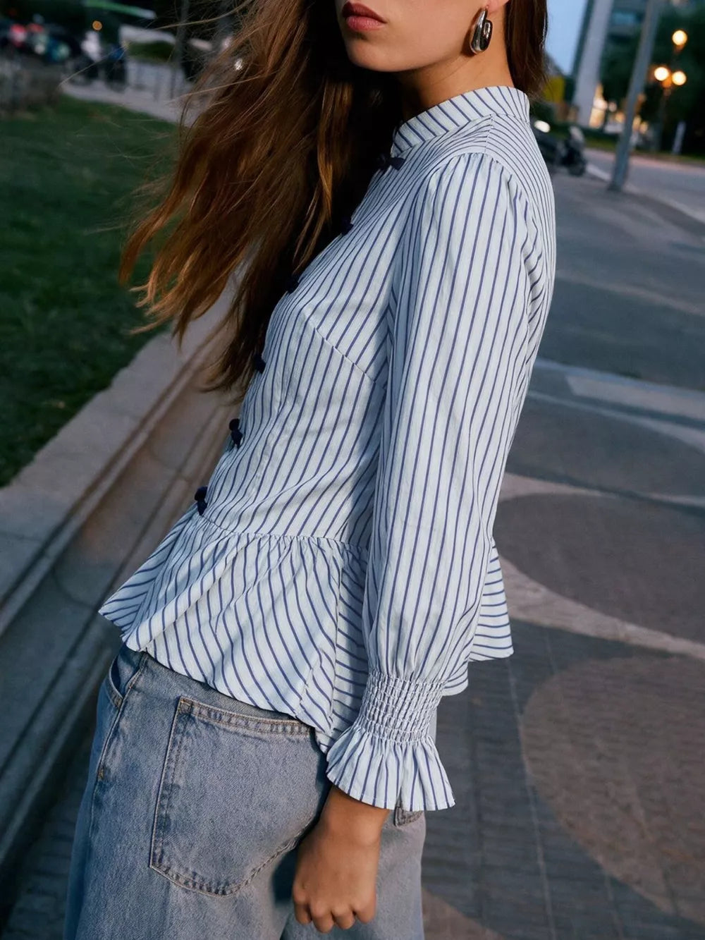 navy blue peplum top featuring ruffled and striped