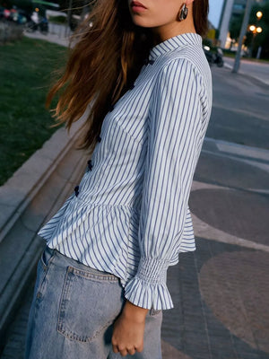 navy blue peplum top featuring ruffled and striped