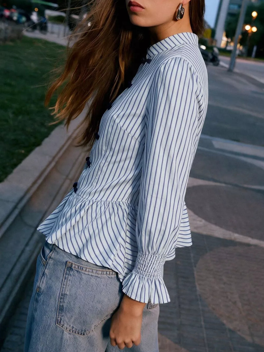 navy blue peplum top featuring ruffled and striped