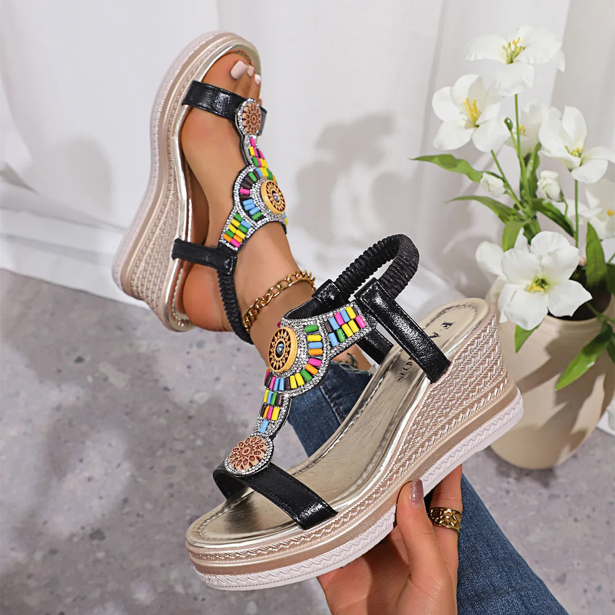 Black embellished platform wedge sandals with colorful beads and woven detail.