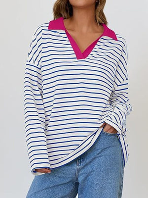 Oversized striped long-sleeve sweatshirt with a contrast pink collar and V-neck.