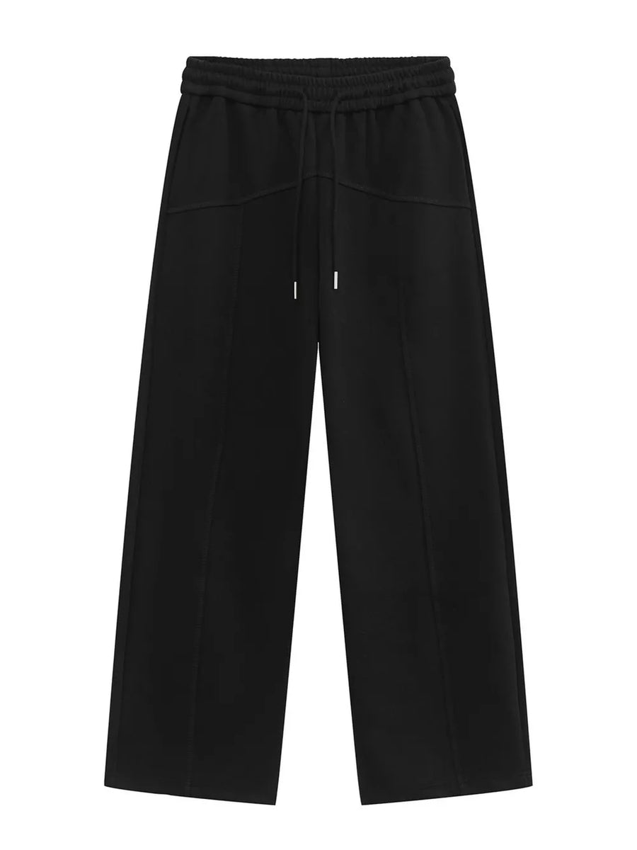 Black cotton sweatpants with drawstring waist and wide legs.