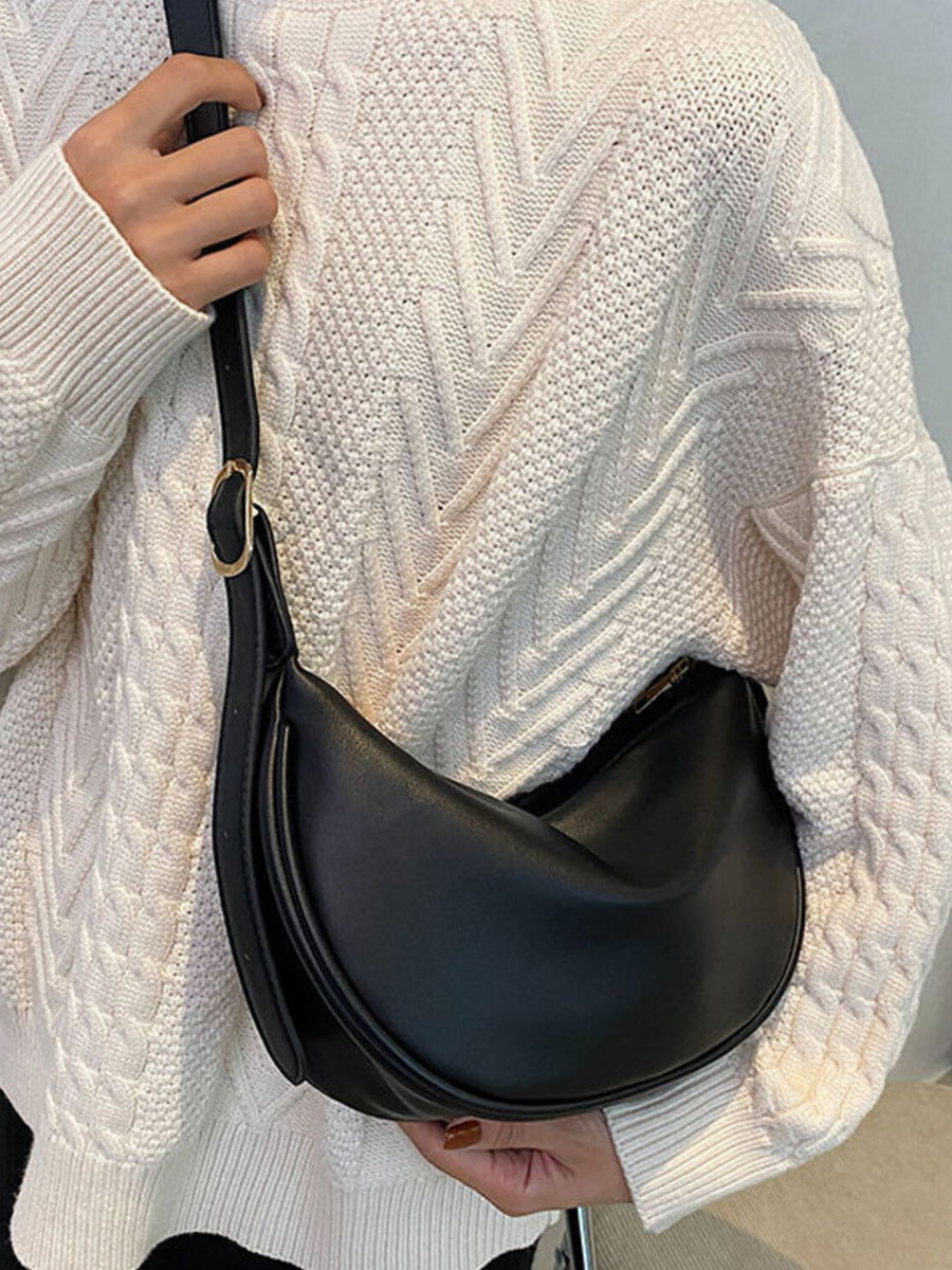Black crescent pu leather crossbody bag with adjustable strap and gold buckle detail.