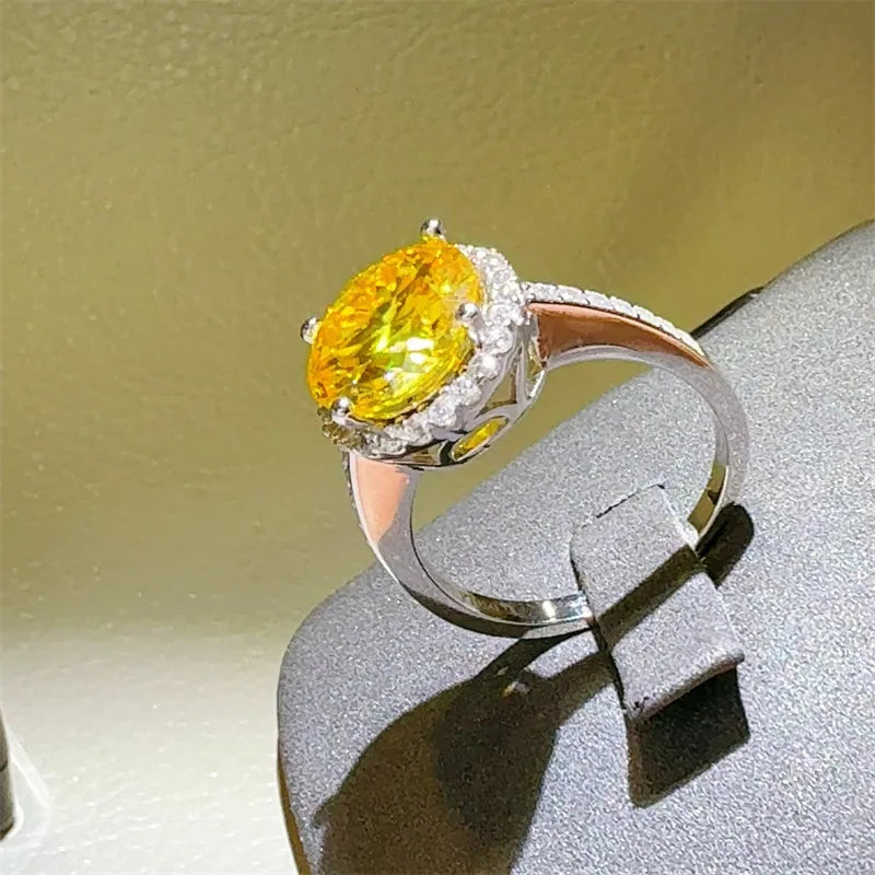 Sterling silver ring with large yellow oval moissanite and halo of small diamonds