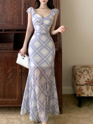 Blue ruched plaid bodycon maxi dress with ruffled cap sleeves and sweetheart neckline.