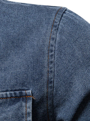 Light blue denim shirt with visible stitching and a chest pocket detail.