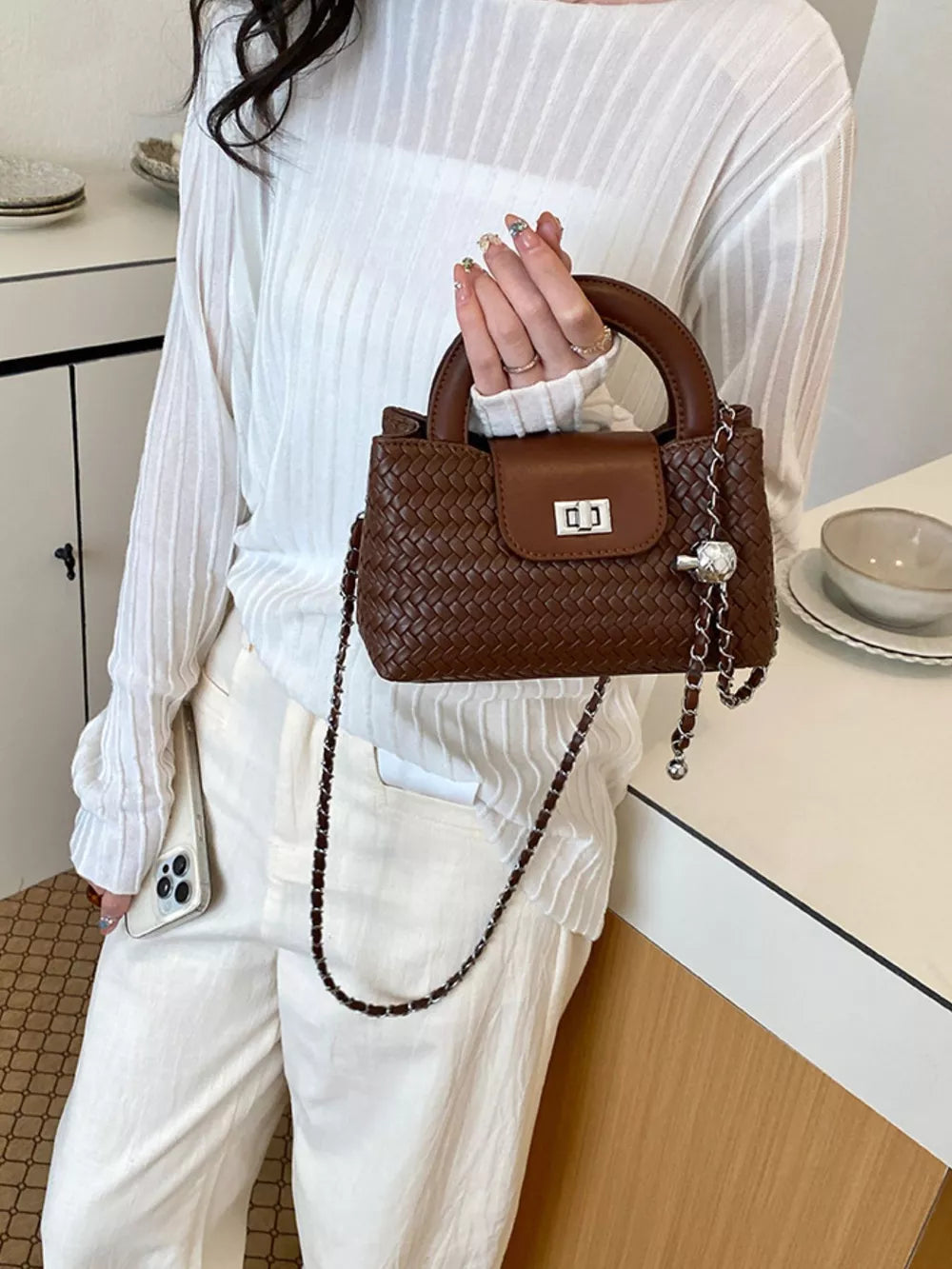 Brown crossbody bag featuring woven texture and woven