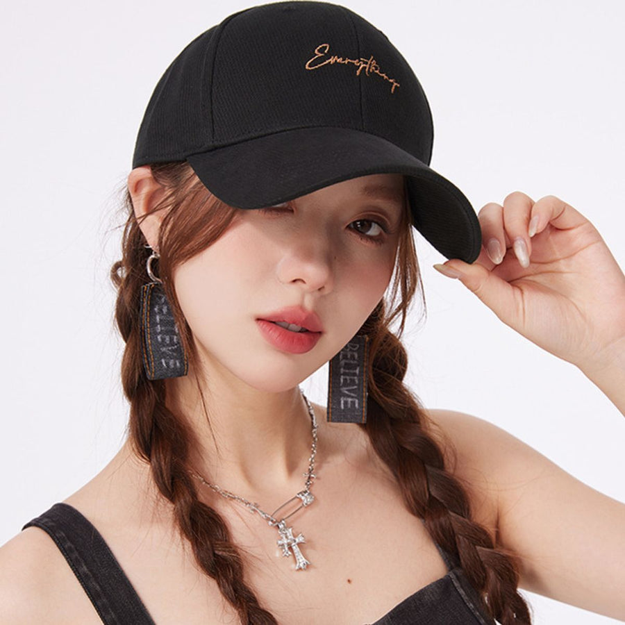 Black cotton baseball cap with cursive embroidery and curved brim