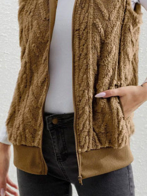 Camel faux fur zip-up vest with textured pattern and ribbed hem.