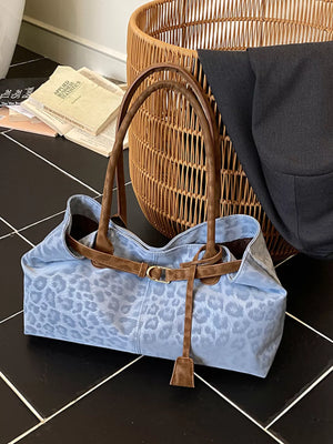 Blue leopard print PU leather shoulder bag with brown trim and buckle detail.