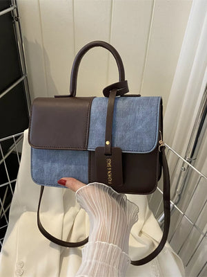 Chic two-tone PU leather handbag with denim accents and a brown top handle.