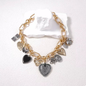 Gold necklace featuring charm details and mixed charm