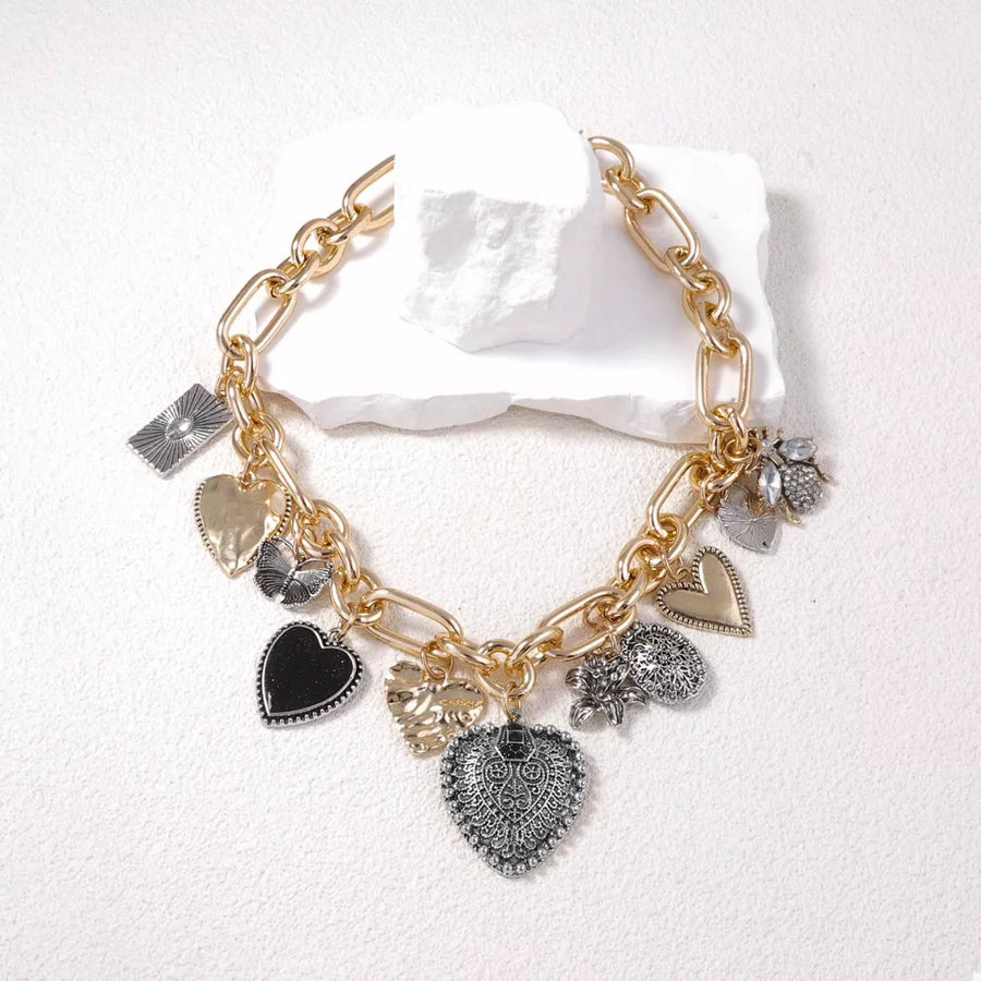 Gold necklace featuring charm details and mixed charm