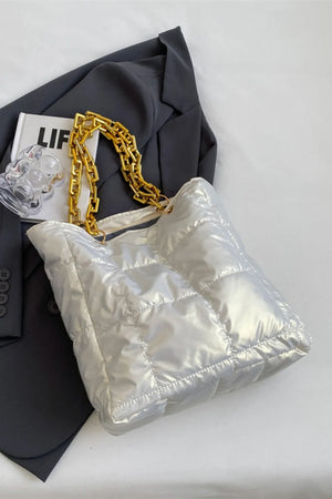 Quilted nylon tote bag in white with gold chain handle.