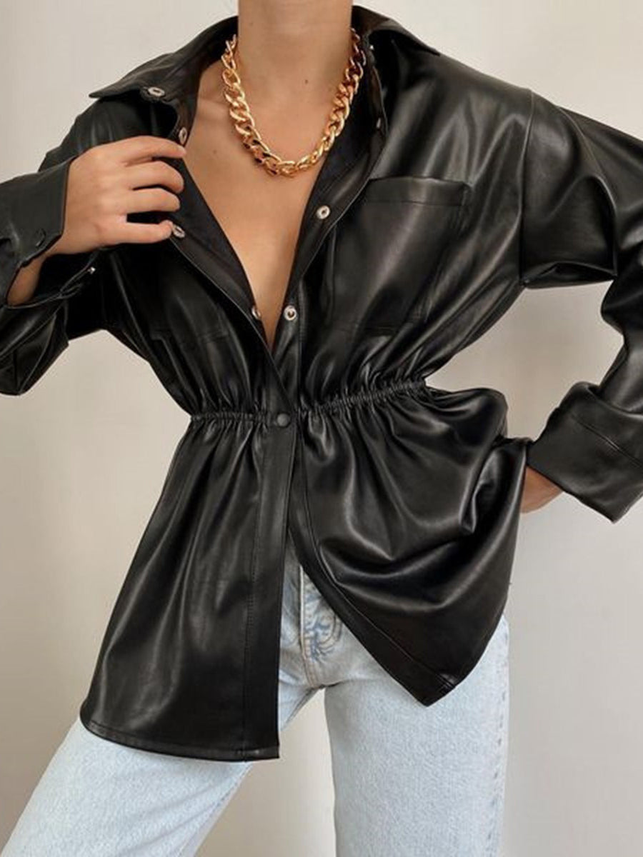 Black faux leather shirt jacket with gathered waist and button front, styled with jeans.