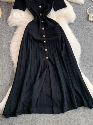 Black ribbed knit midi dress with gold button detail and front slit