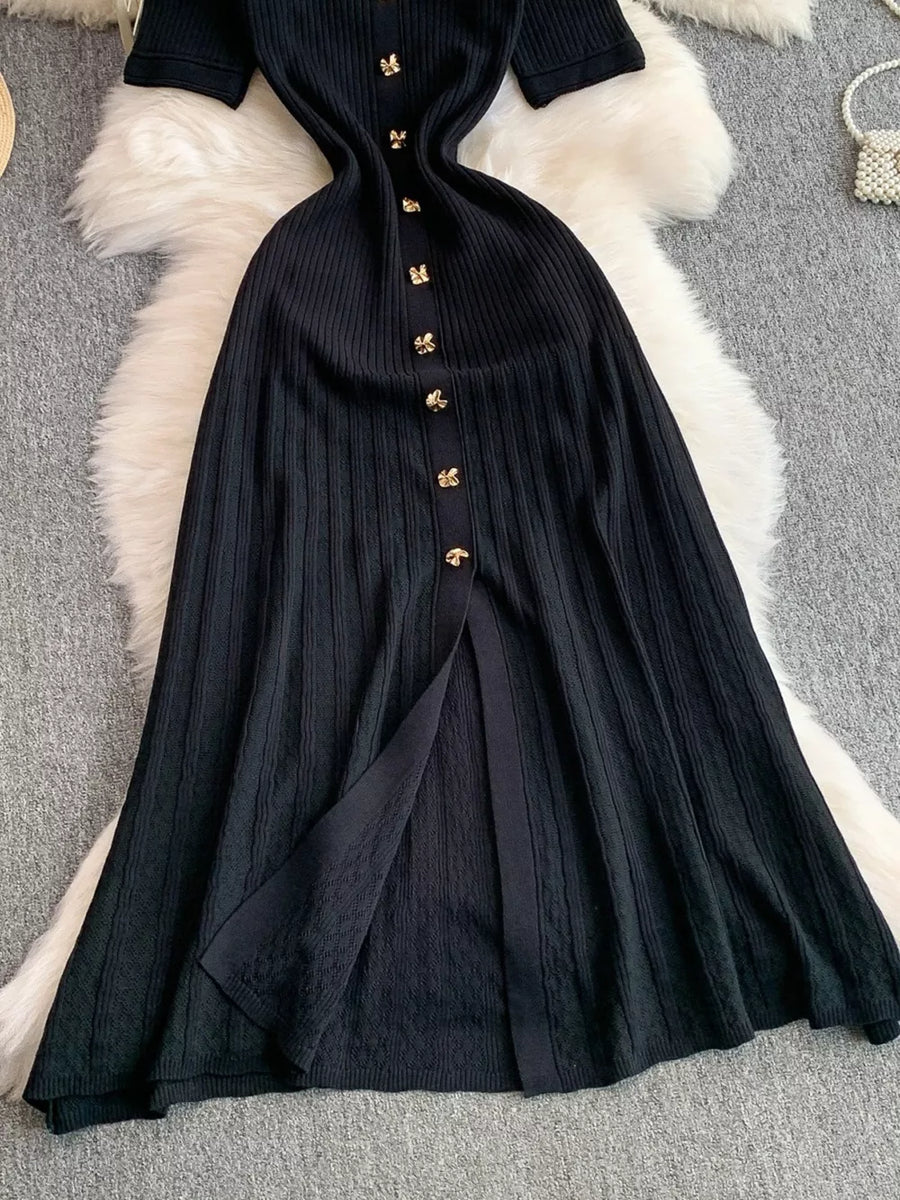 Black ribbed knit midi dress with gold button detail and front slit