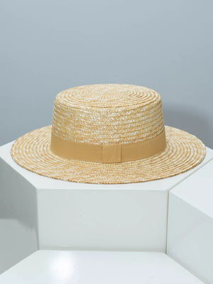 Women's straw boater hat with tan ribbon band.