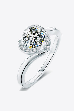 Silver moissanite ring with a heart-shaped halo and round center stone.