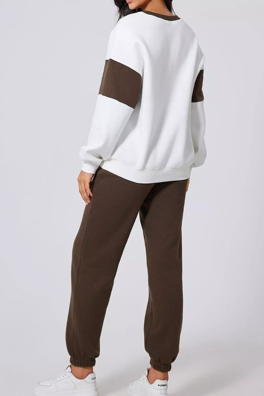 Oversized active set with white crewneck sweatshirt featuring chocolate color-block sleeves and matching chocolate