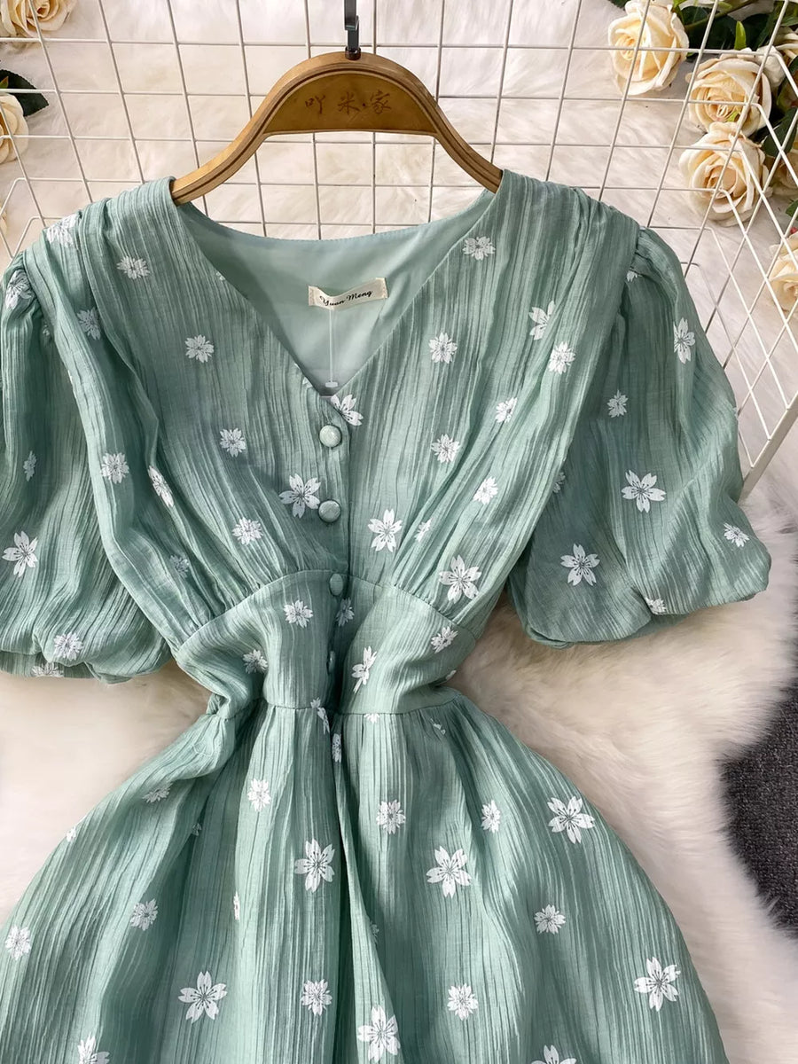 Light green embroidered puff sleeve midi dress with button front and v-neck.