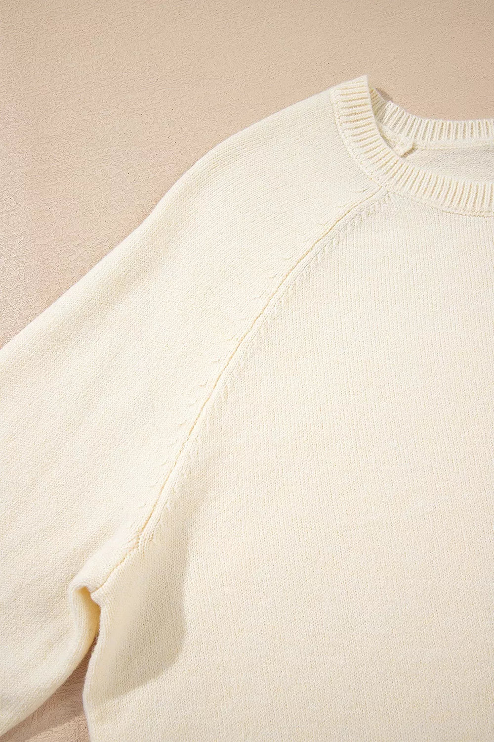 pullover sweater in White with decorative buttons and hip-length