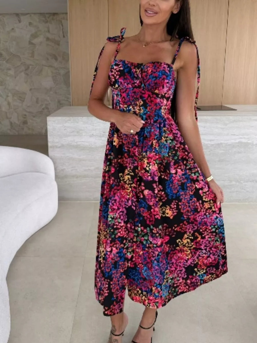 Floral tie-strap midi dress with a sweetheart neckline and A-line skirt in a vibrant multicolor floral print.