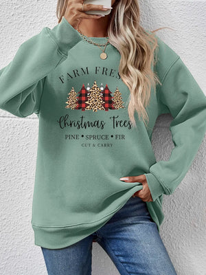 Sage crewneck sweatshirt with Christmas Trees graphic and buffalo plaid accents.