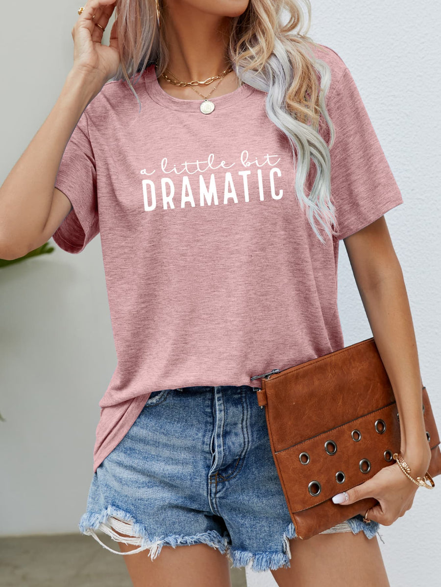 Blush pink crew neck tee with white text graphic a little bit DRAMATIC, short sleeves.
