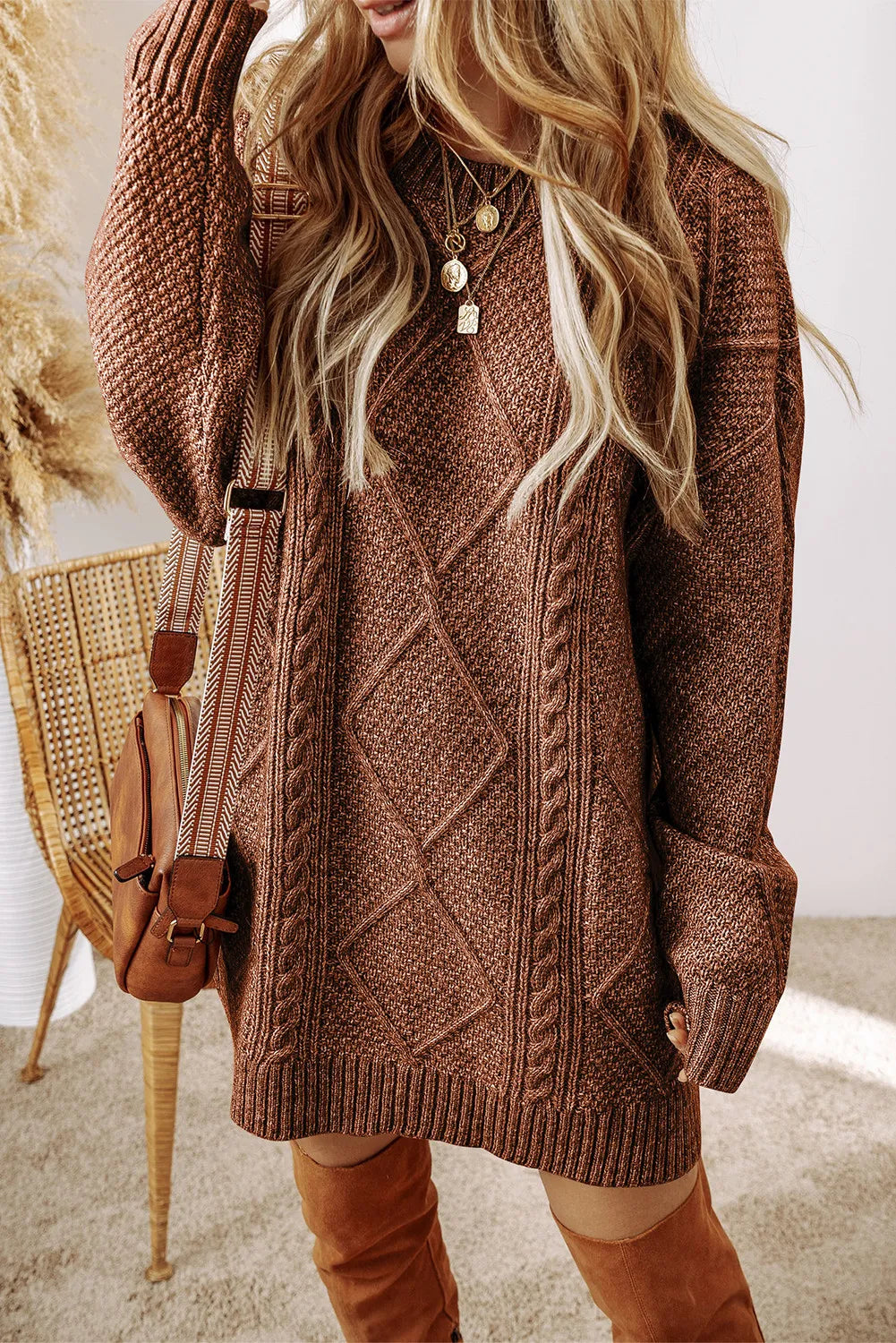 Tan cable knit sweater dress with diamond pattern and braided details.
