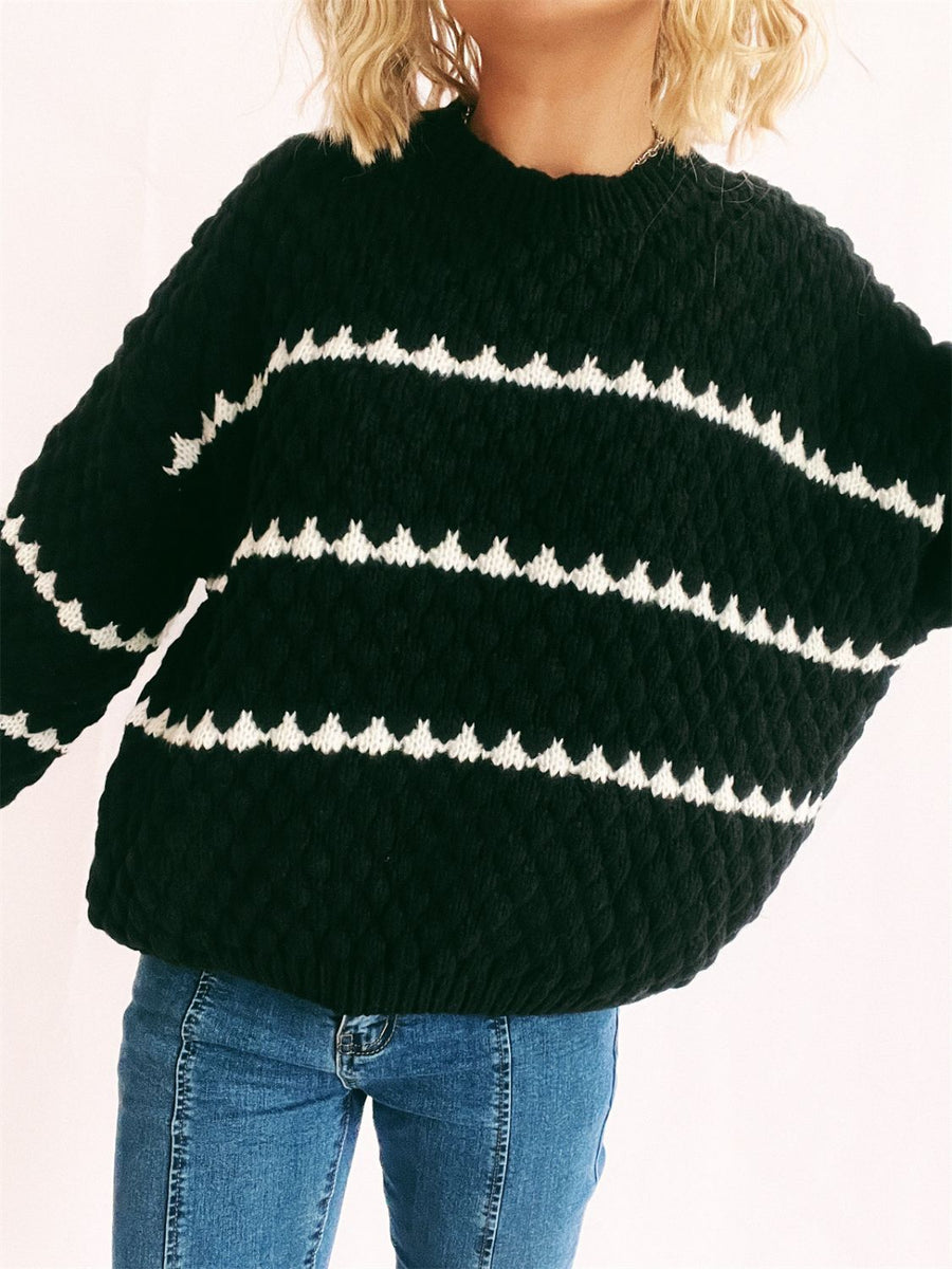 Black textured knit jumper with white chevron stripes and a crew neck.