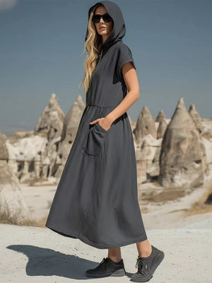Grey hooded midi dress with short sleeves and functional pockets, styled casually.