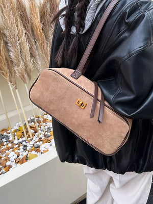 Khaki suede shoulder bag with gold clasp and leather trim.