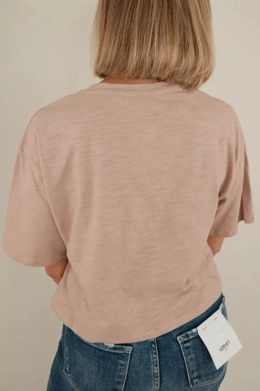 Beige cotton crew neck t-shirt with short sleeves and a relaxed fit.