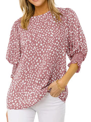 Pink animal print half sleeve blouse with smocked cuffs and puffed sleeves.