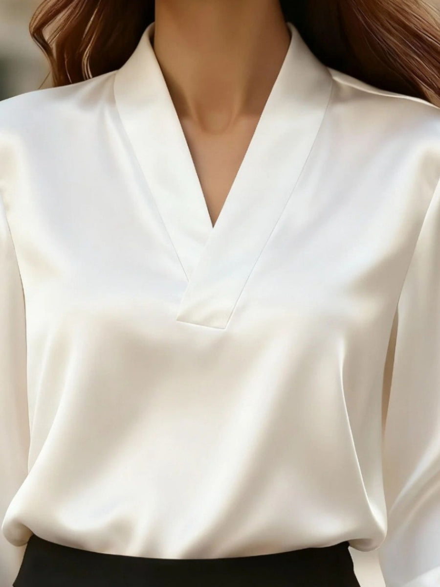 Elegant white satin V-neck blouse with a subtle sheen, perfect for a chic look.