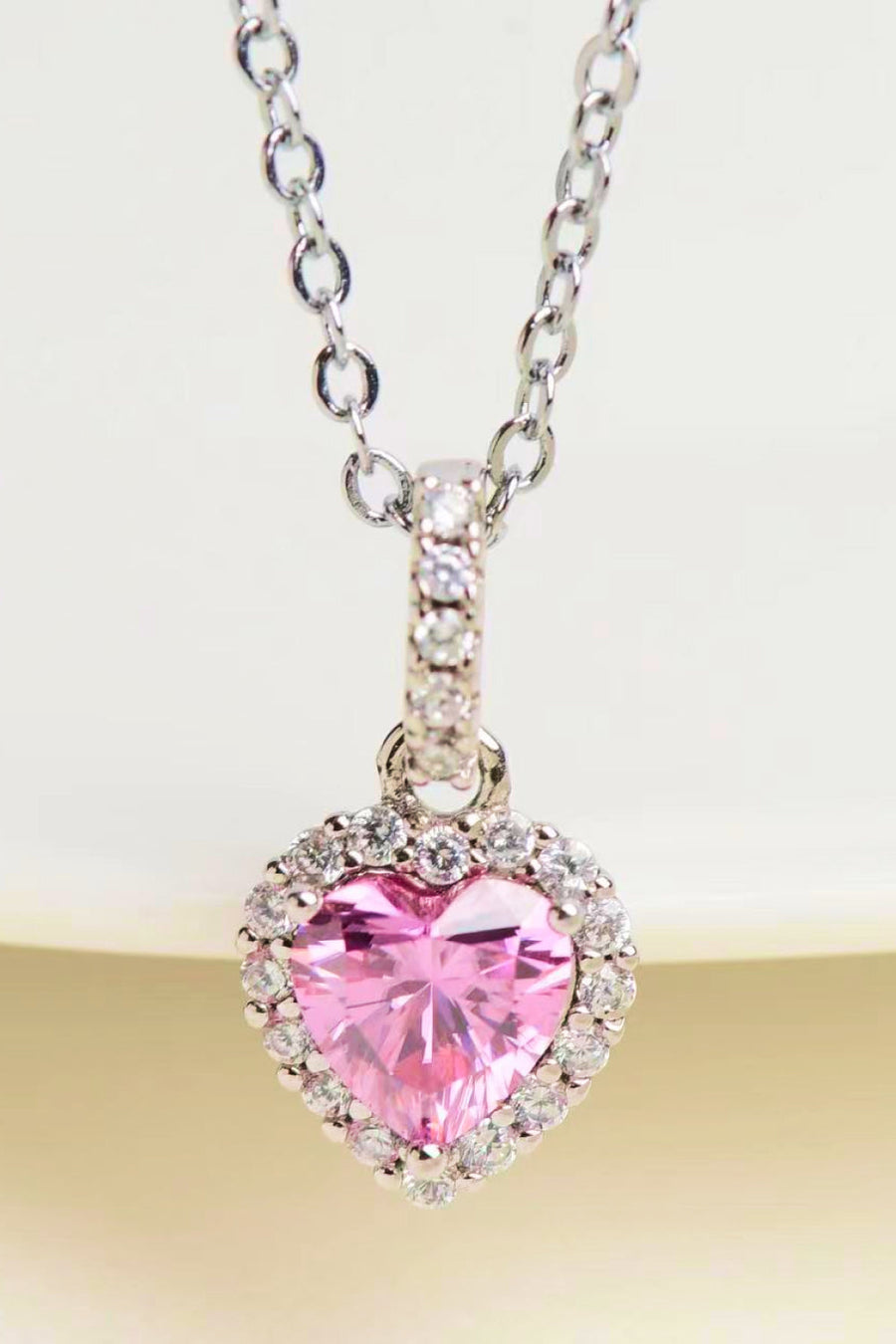Pink heart halo pendant necklace in 925 sterling silver with clear cubic zirconia accents.